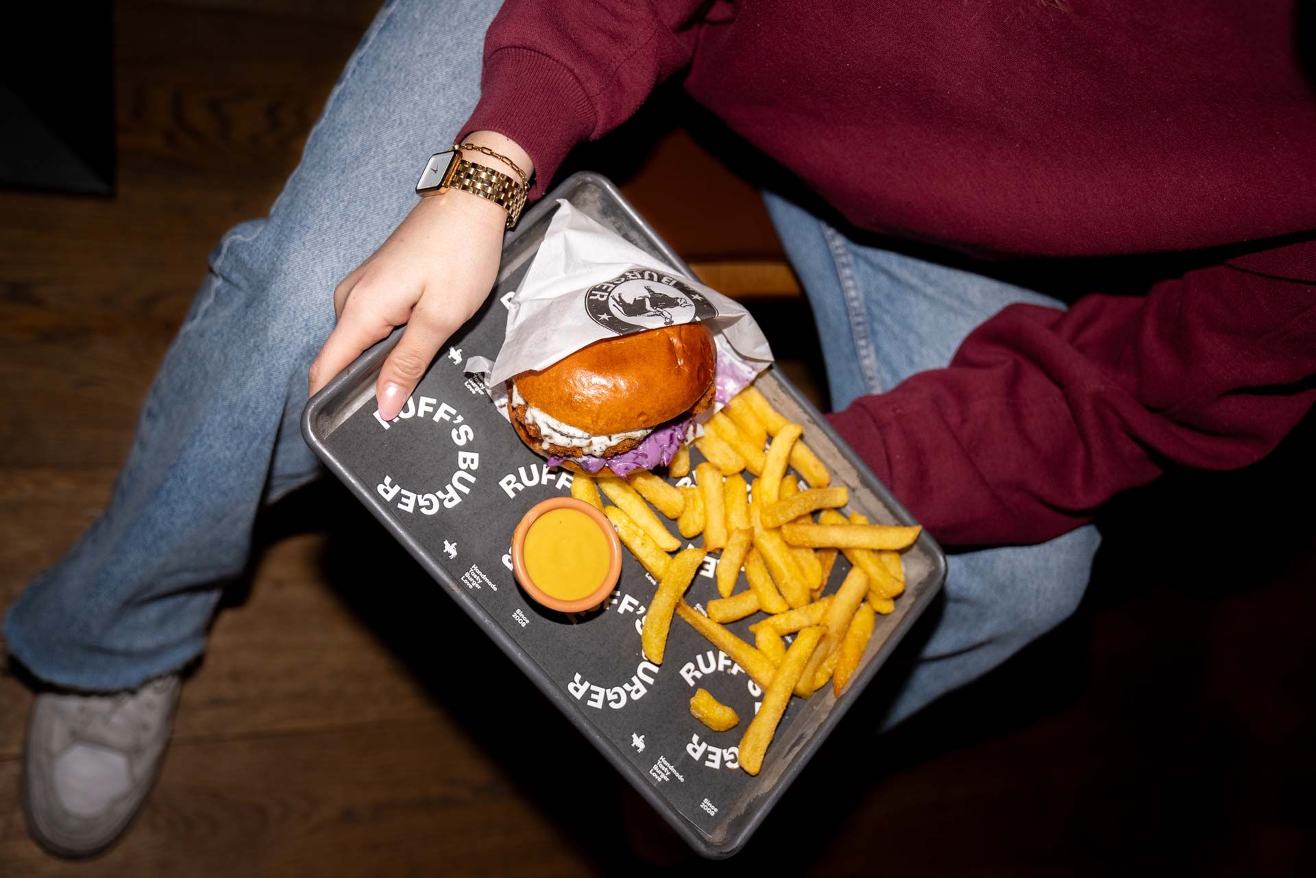 Tablett mit Burger, Pommes und Sauce.